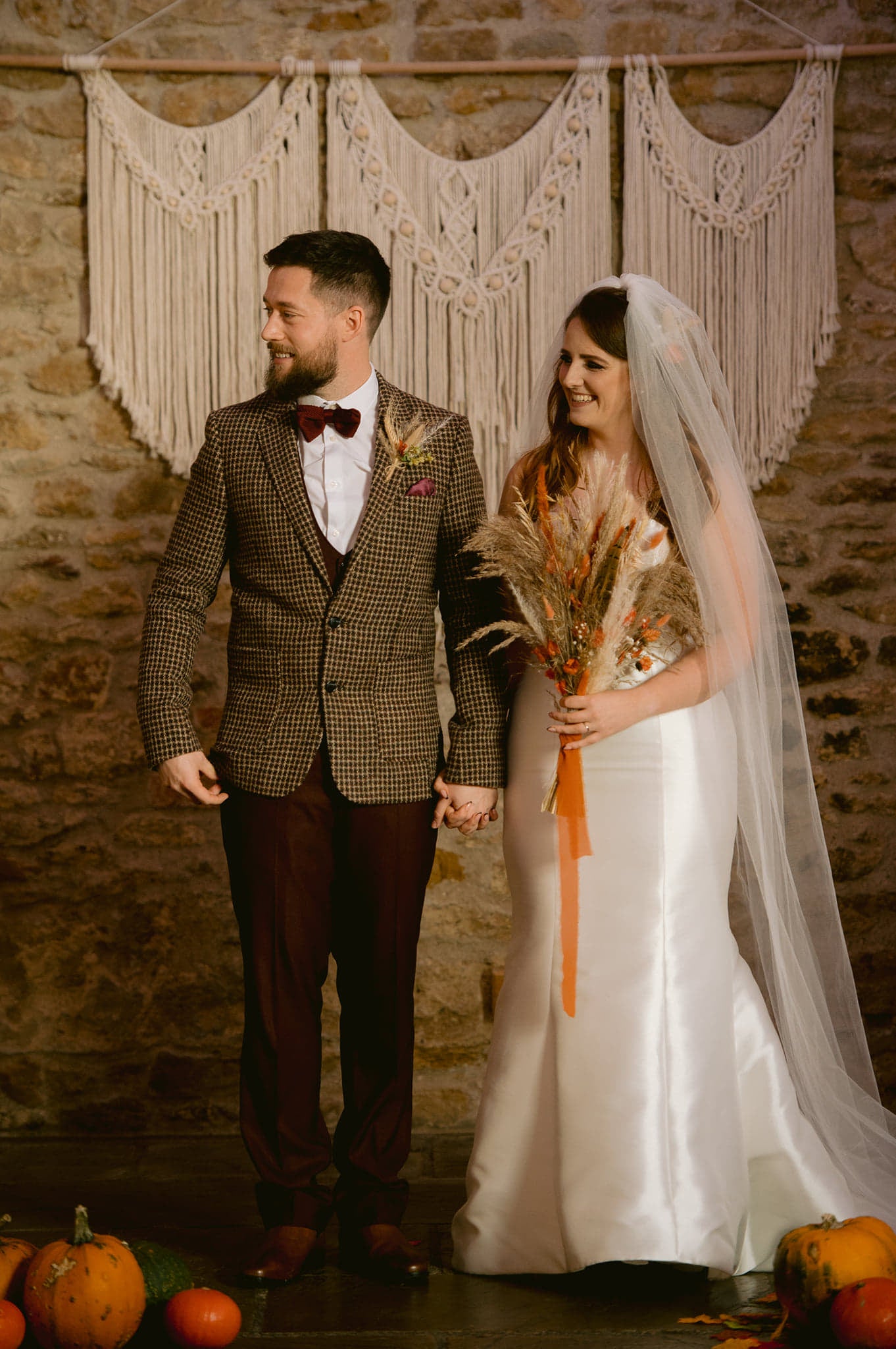 couple with macrame wedding backdrop